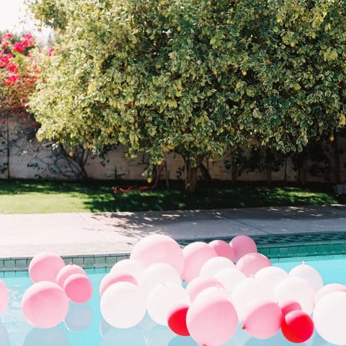large pink balloon floating in pool