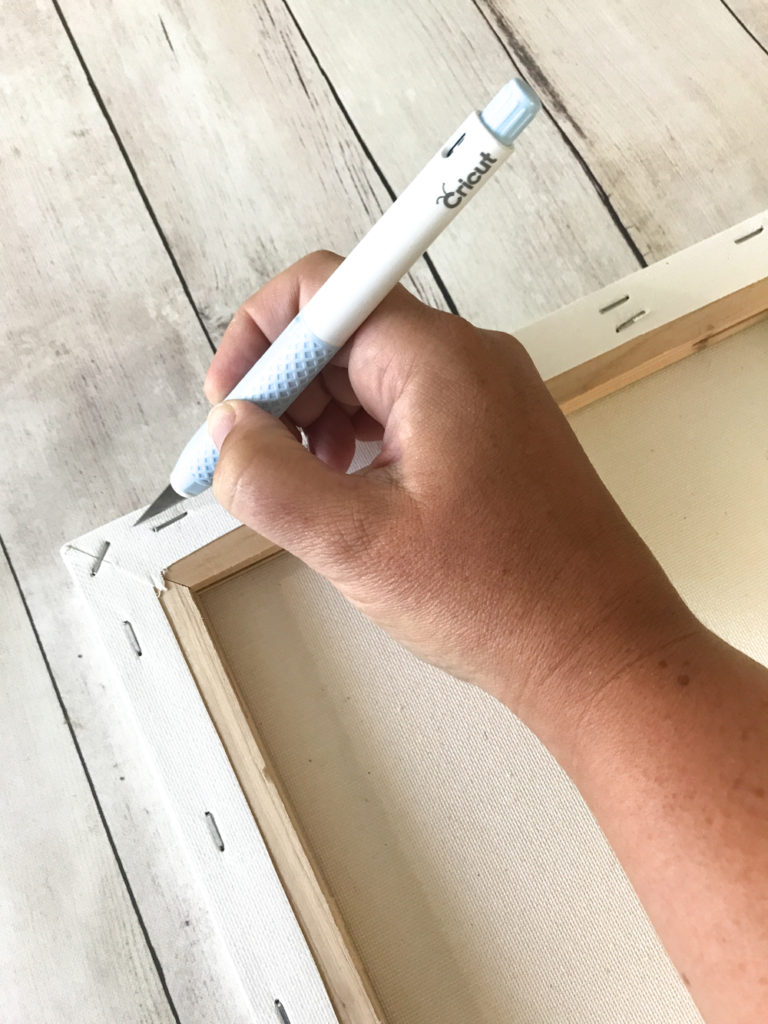 Cutting the Canvas off the frame using the Cricut TrueControl Knife to make a Reverse Canvas Project