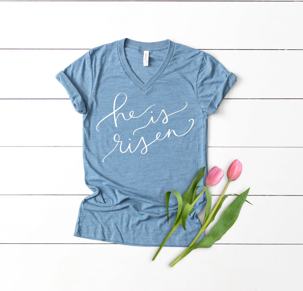 He is Risen Religious Easter SVG on Blue Shirt by Pineapple Paper Co.