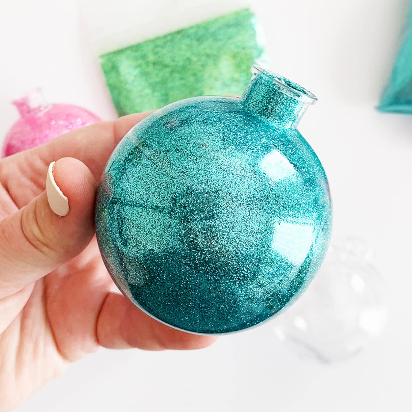 hand holding aqua diy easy glitter ornament