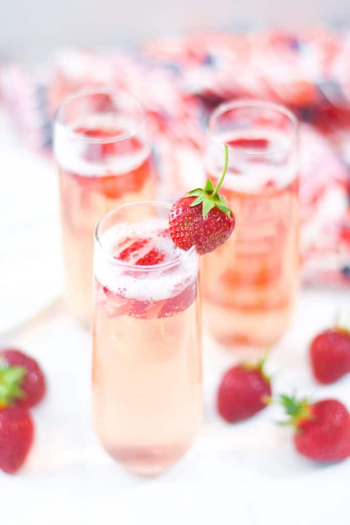 Strawberry Bellini with Fresh Sliced Strawberries and Whole Strawberry Garnish