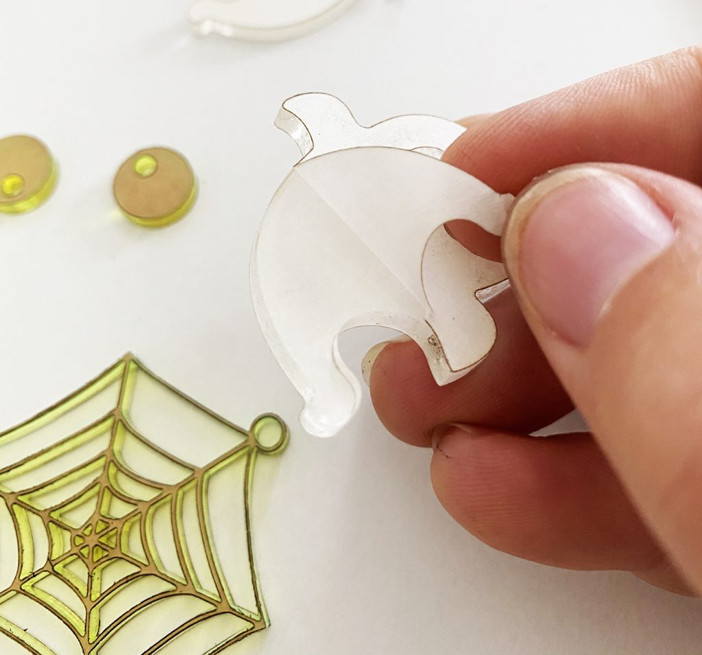 Peeling Mask off of DIY Acrylic Ghost Earrings on Glowforge