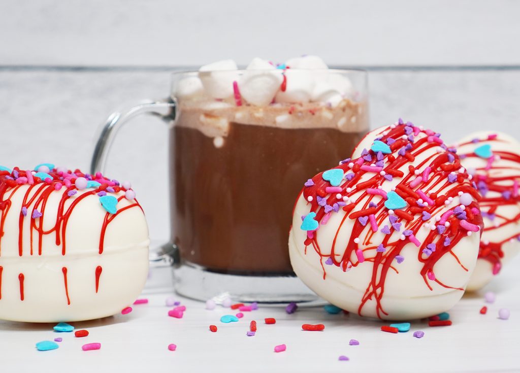 Heart Shaped Valentine Hot Cocoa Bomb with Glass Mug of Hot Chocolate
