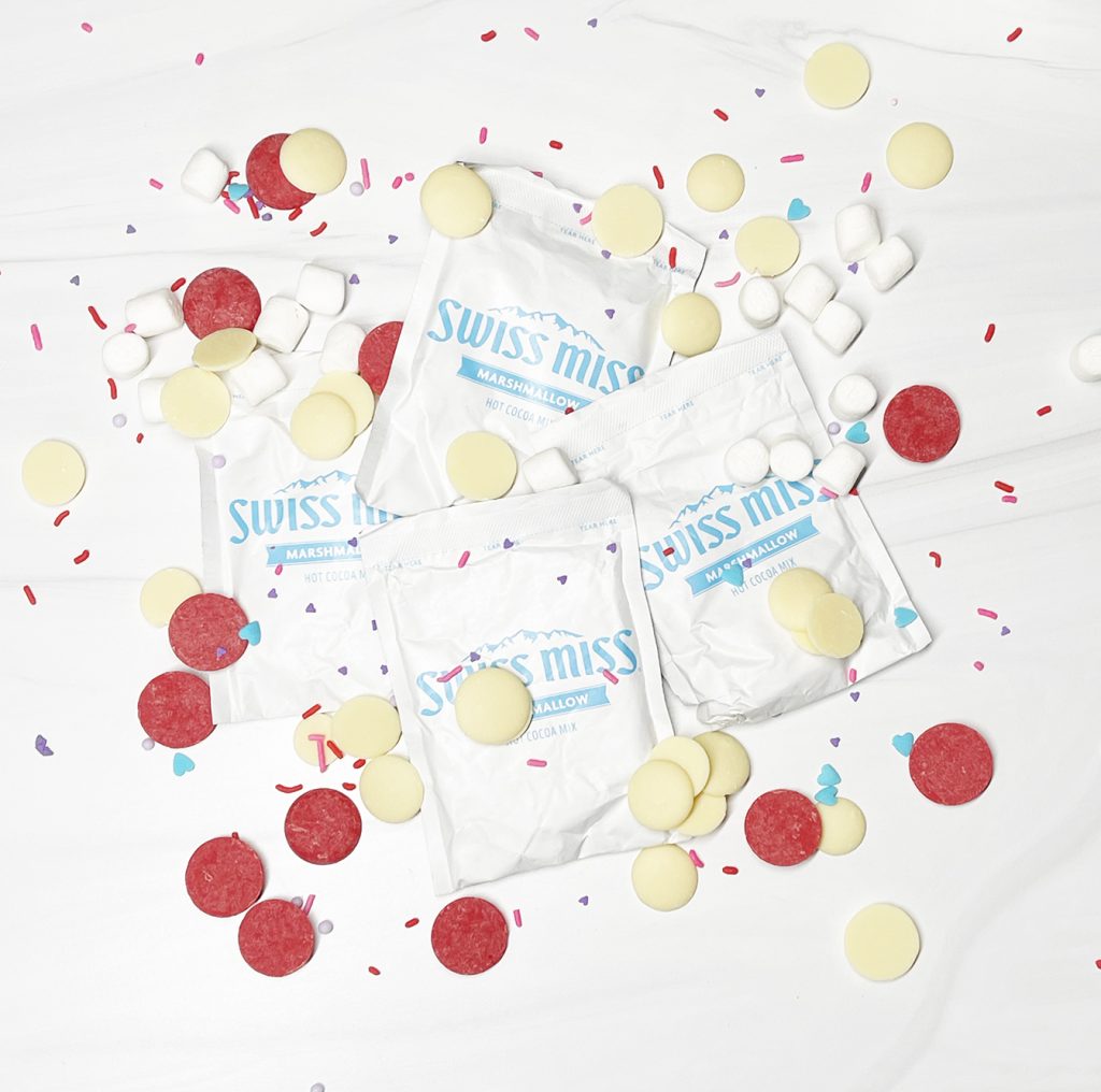 Swiss Miss Hot Chocolate Packets and Candy Coating with Sprinkles to make Hot Cocoa Bombs for Valentine's Day