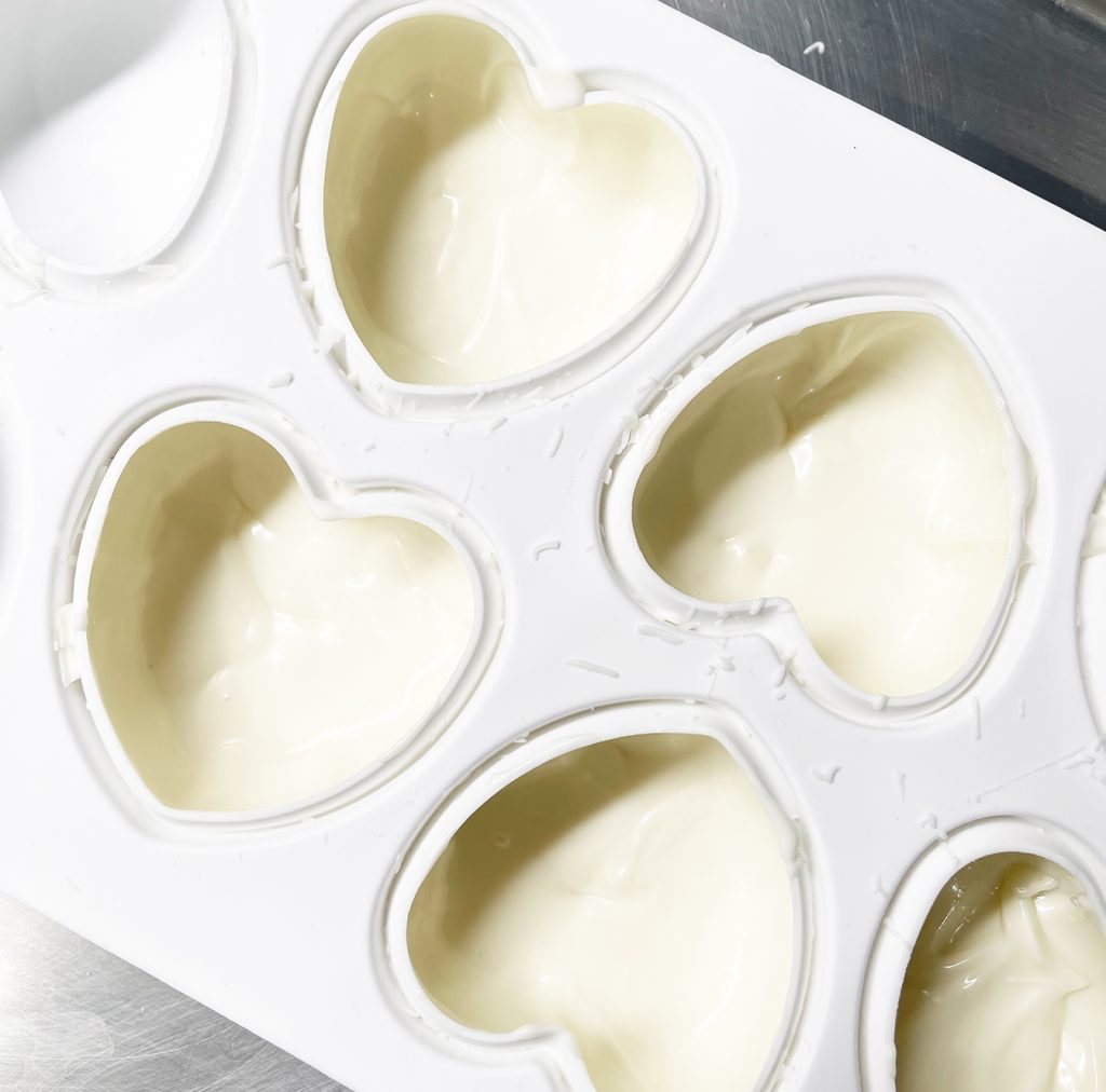 White Chocolate in Heart Shaped Silicone Mold to Make Hot Chocolate Bombs