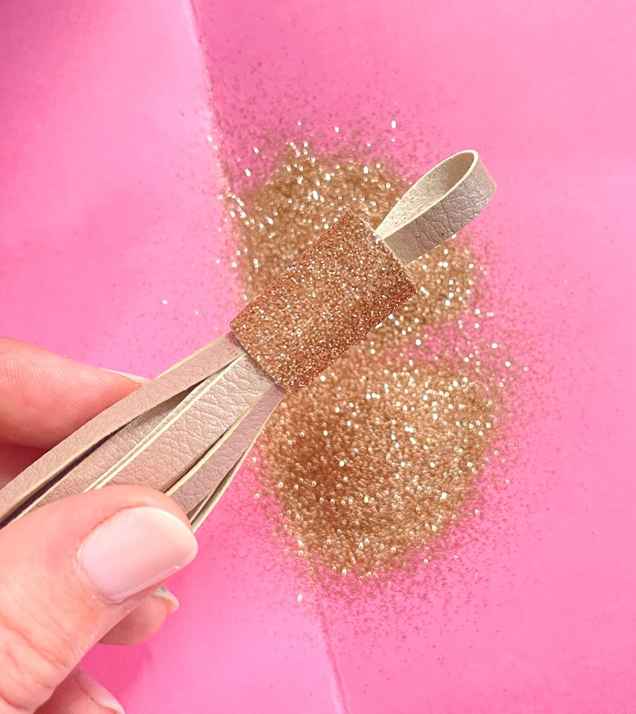 Adding Gold Glitter to Faux Leather DIY Tassel Made with Cricut