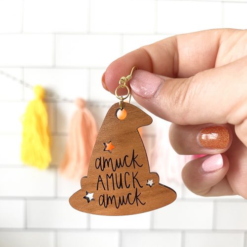 DIY Laser Cut Wooden Hocus Pocus Halloween Earring held by hand
