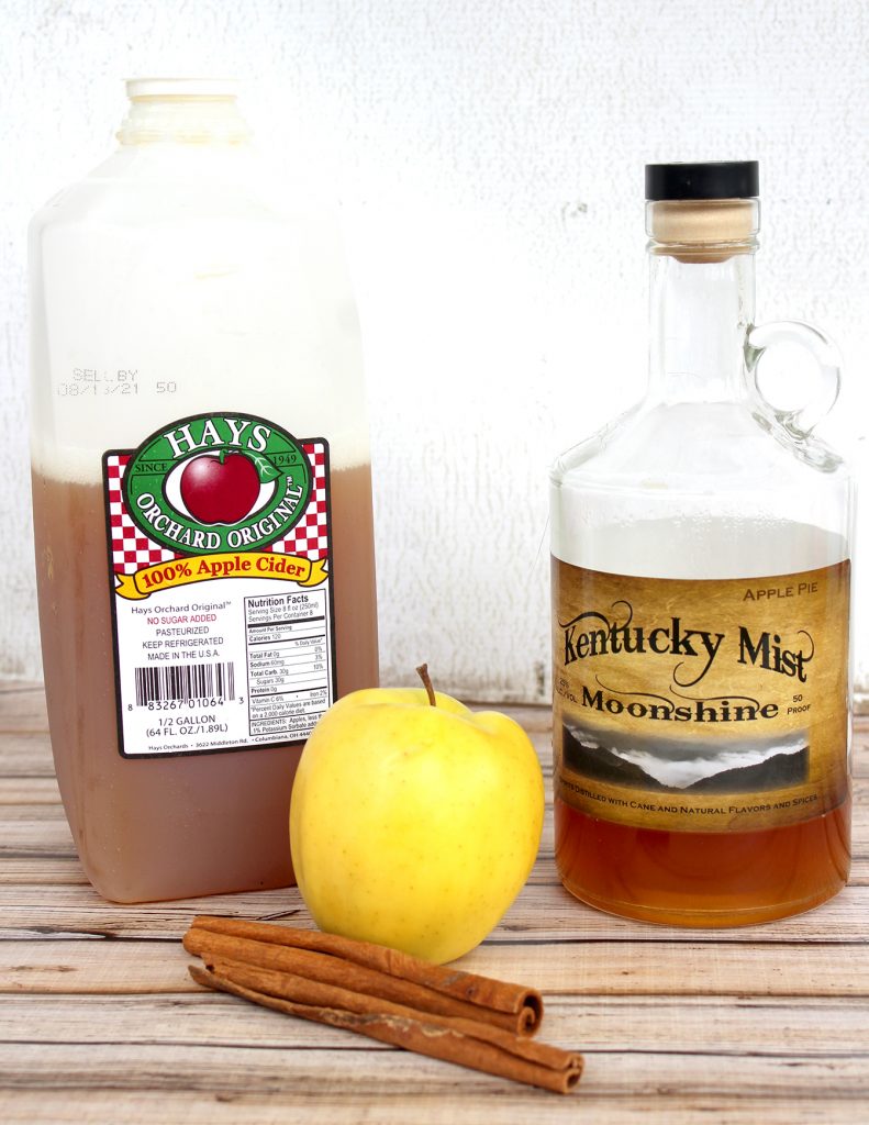 Apple Cider, Apple Pie Moonshine, Apple, and Cinnamon Sticks for Apple Pie Moonshine Cocktail Recipe