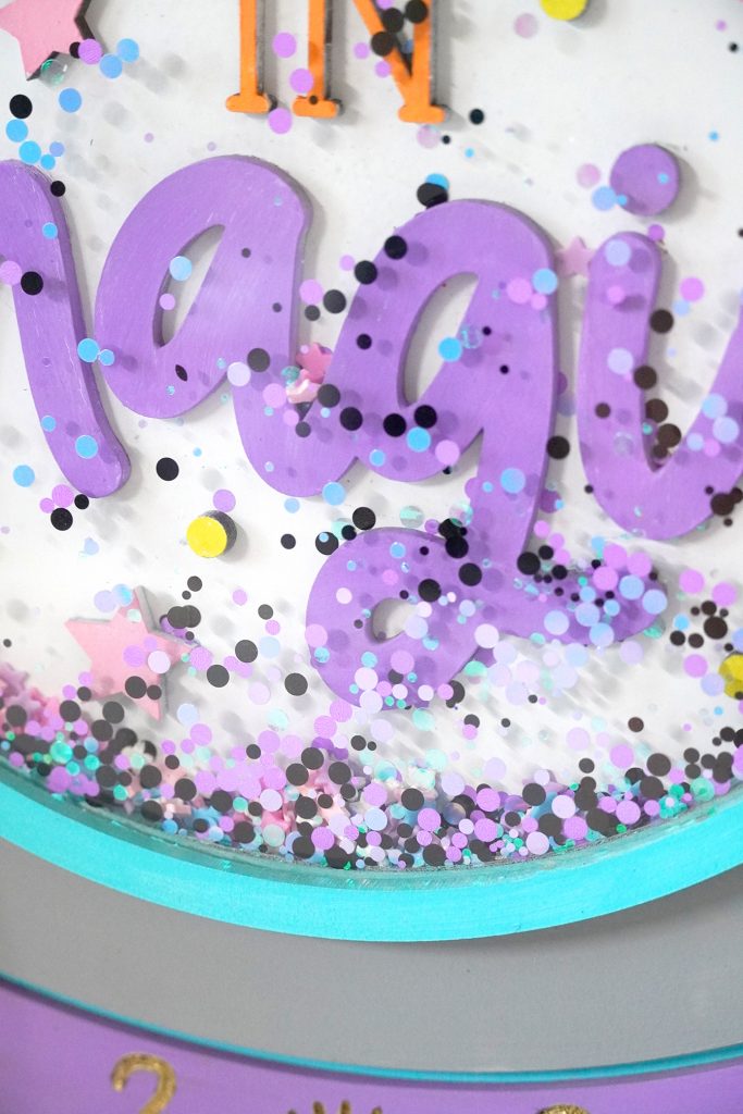 Close Up of Crystal Ball Shaker Sign with Glitter inside Acrylic
