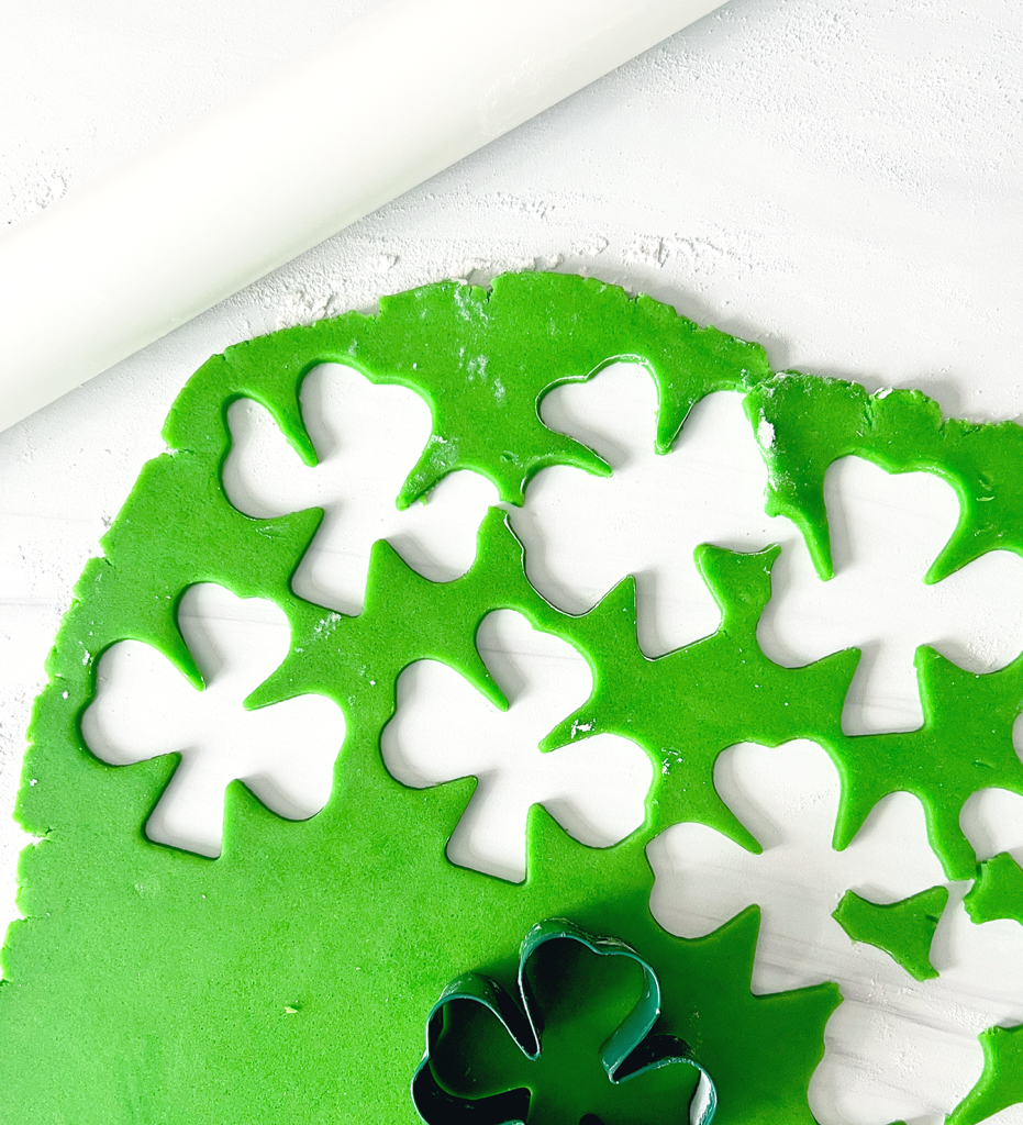 green cookie dough with cut out shamrocks
