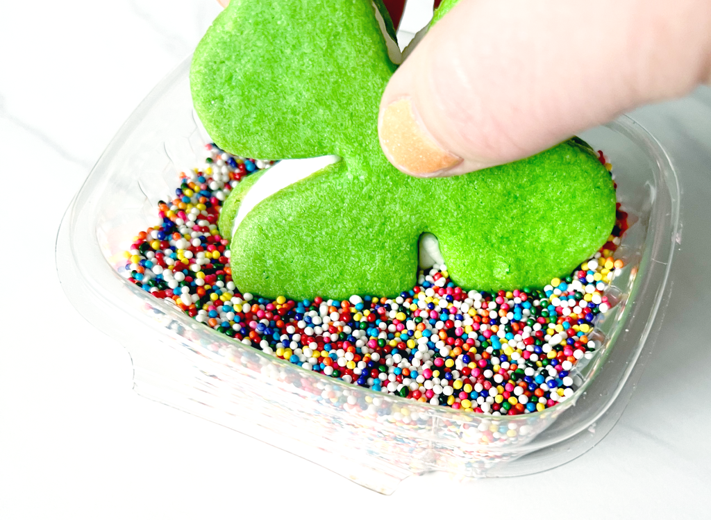 shamrock cookie sandwiches dipped into rainbow sprinkles