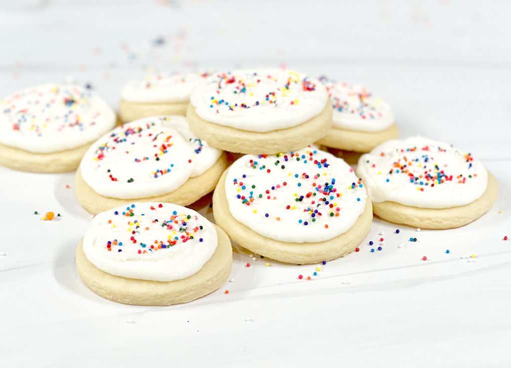 cut out sugar cookies with rainbow sprinkles in pile