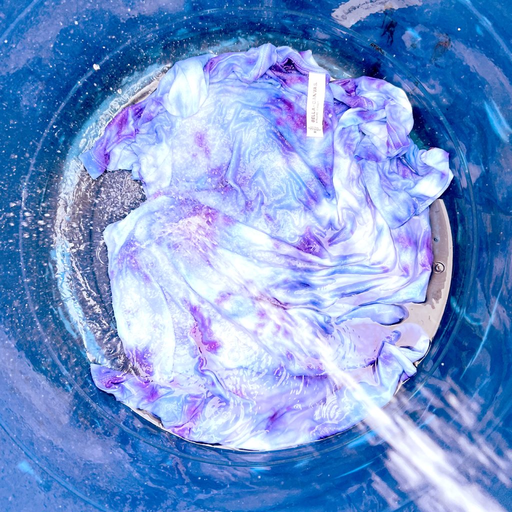 Rinsing out tie dye shirt