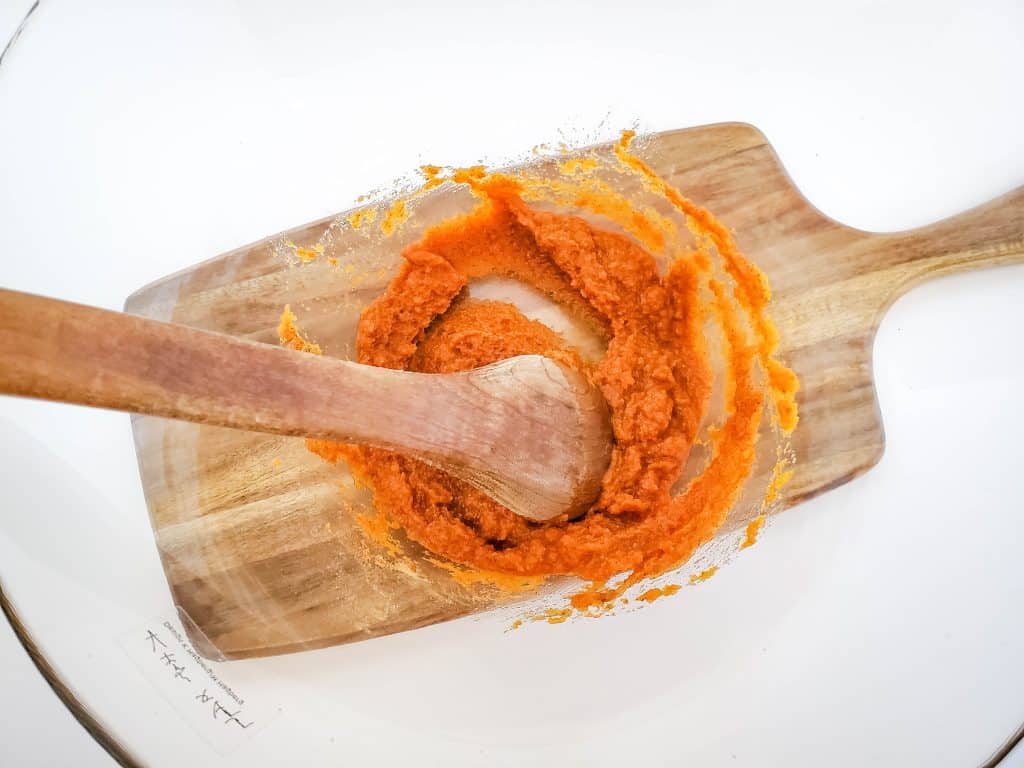 pumpkin pie pinwheel ingredients in bowl being mixed with spoon