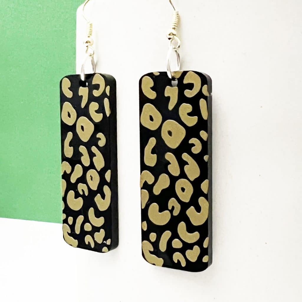close up of vinyl on leopard acrylic earrings cut with xtool m1 laser and blade cutting machine