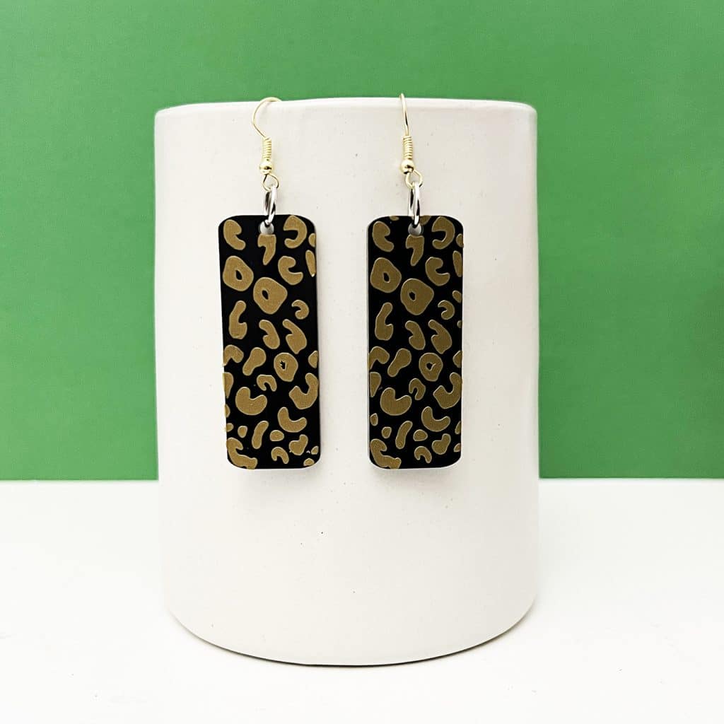 black acrylic and gold vinyl leopard earrings made with xtool m1