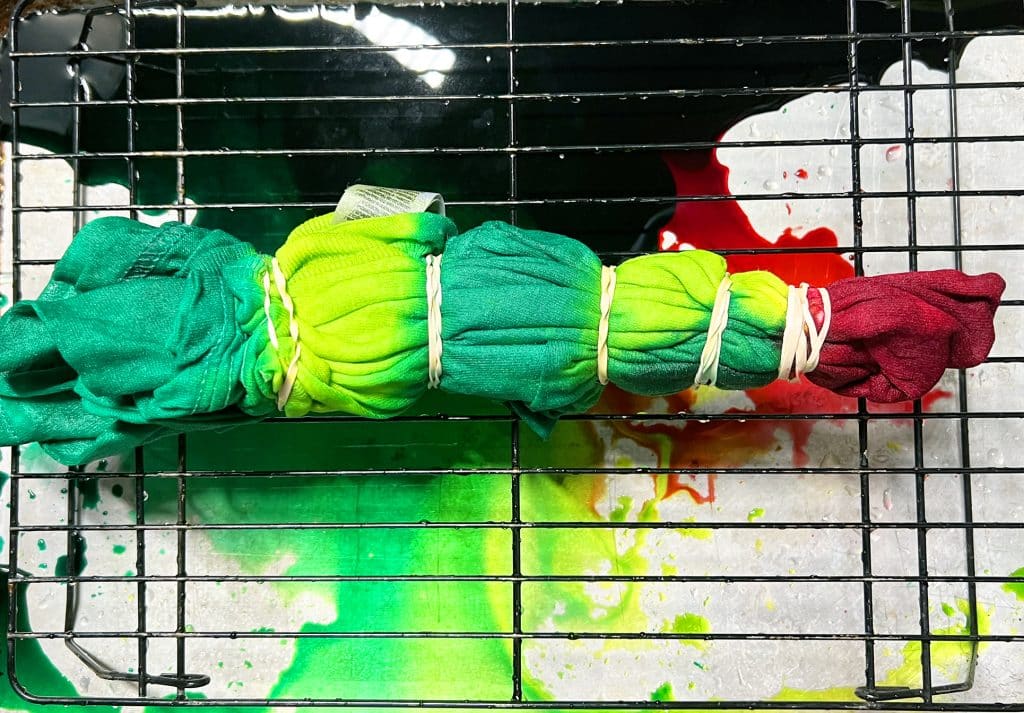 red, lime green, and green dye on grinch tie dye heart shirt