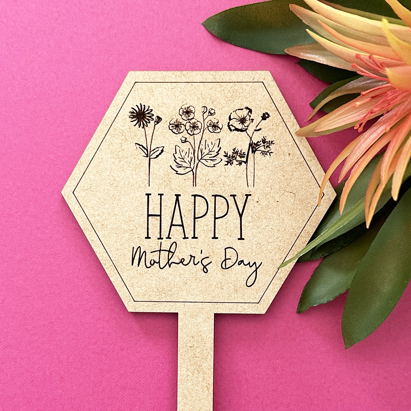 laser cut and engraved plant marker next to tropical plant for mothers day