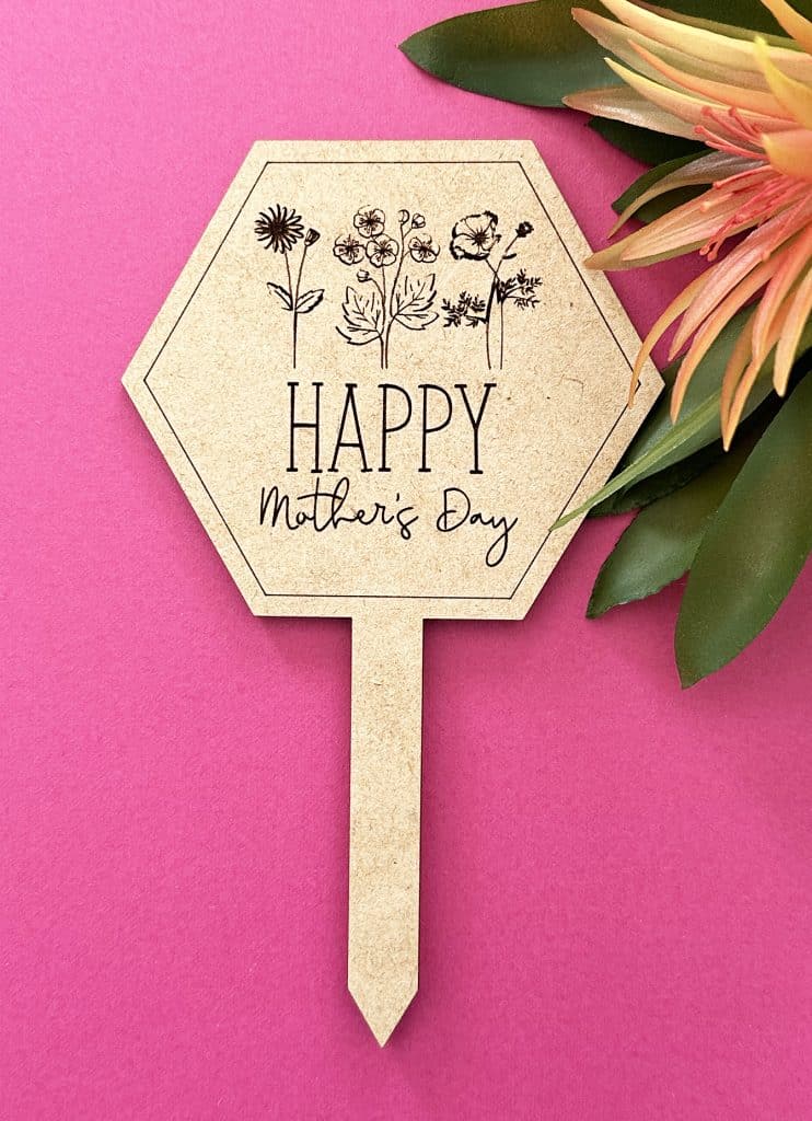 plant marker for mother's day with birth month flowers and tropical flower in background