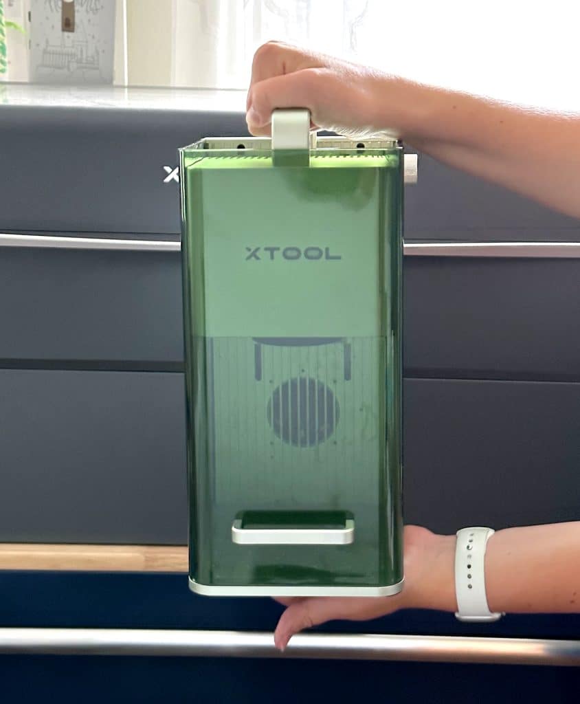 xtool f1 laser engraver and cutter being held up