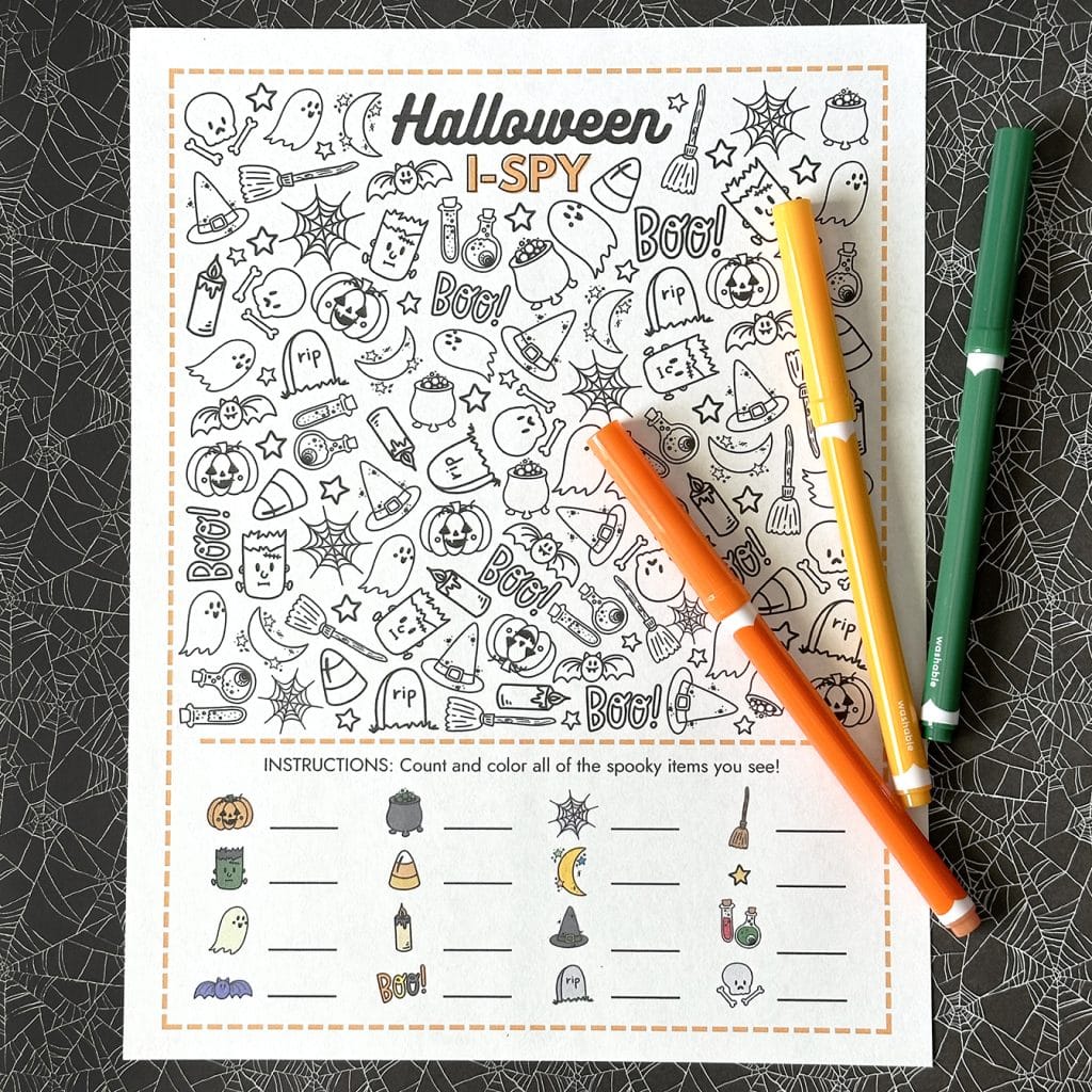 halloween i spy printable game with 3 halloween markers on spiderweb background