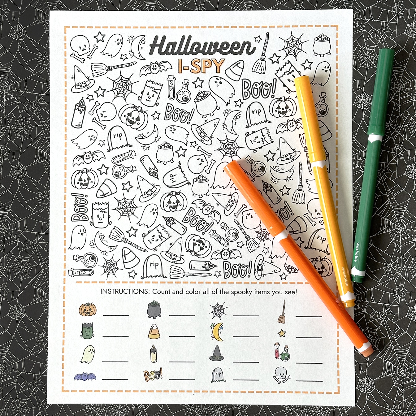 halloween i spy printable game with 3 halloween markers on spiderweb background