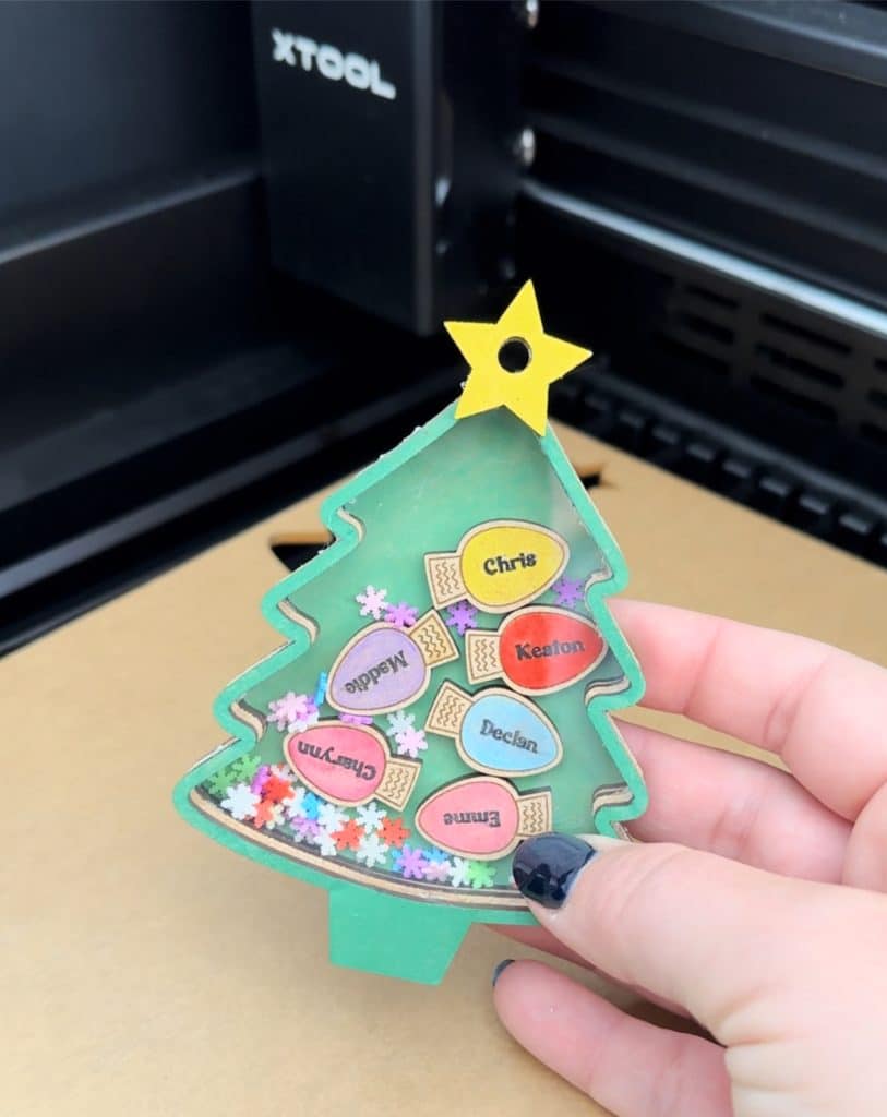 christmas tree personalized family christmas shaker ornament with lights made with xTool laser in background
