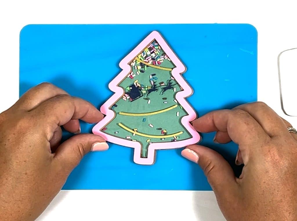 adding top layer to diy shaker christmas ornament with cricut