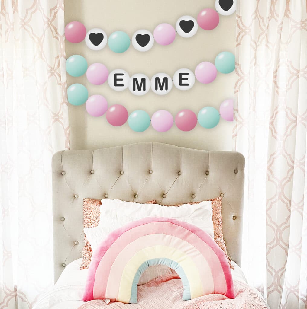 free printable friendship bracelet banner garland above girl room with rainbow pillow