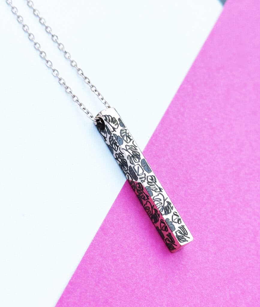 custom metal engraved bar necklace with monsteras