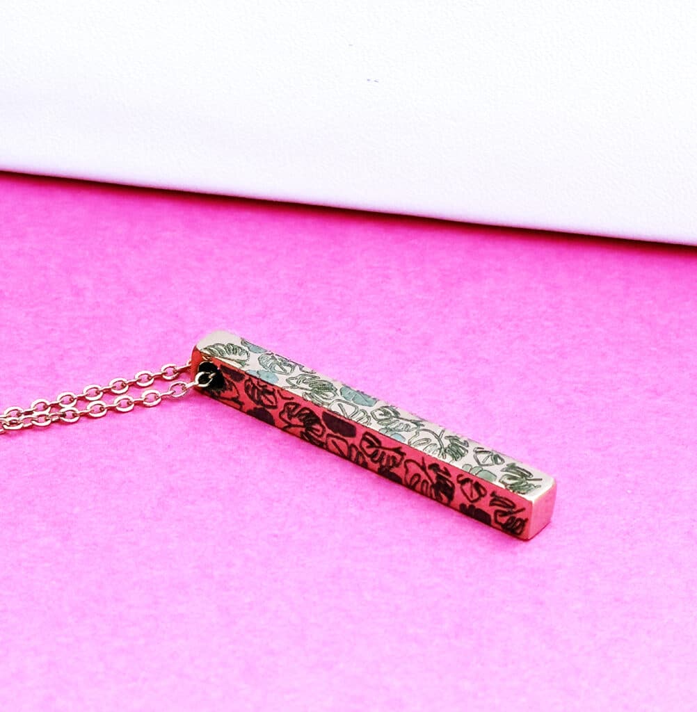 custom metal engraved bar necklace with monsteras