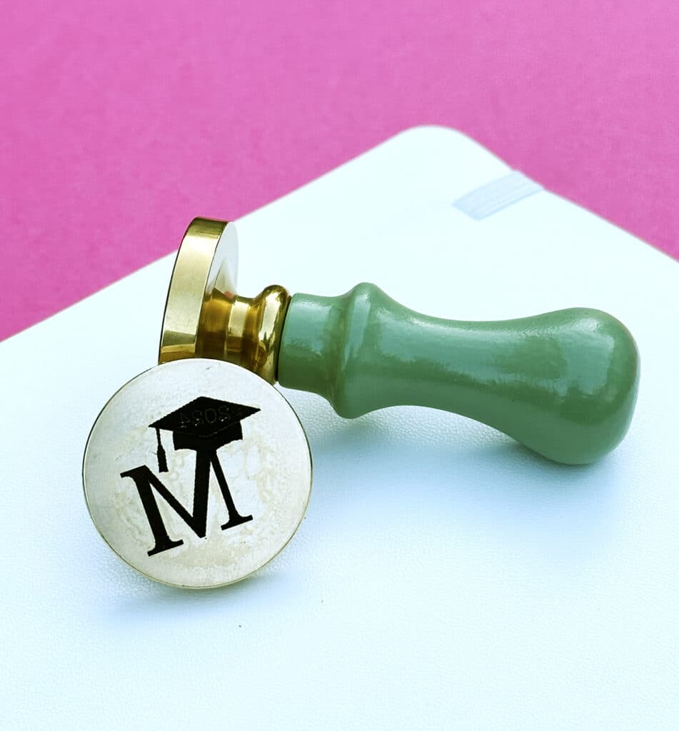 wax seal stamp engraved by xtool f1 ultra with M and graduation cap on the stamp