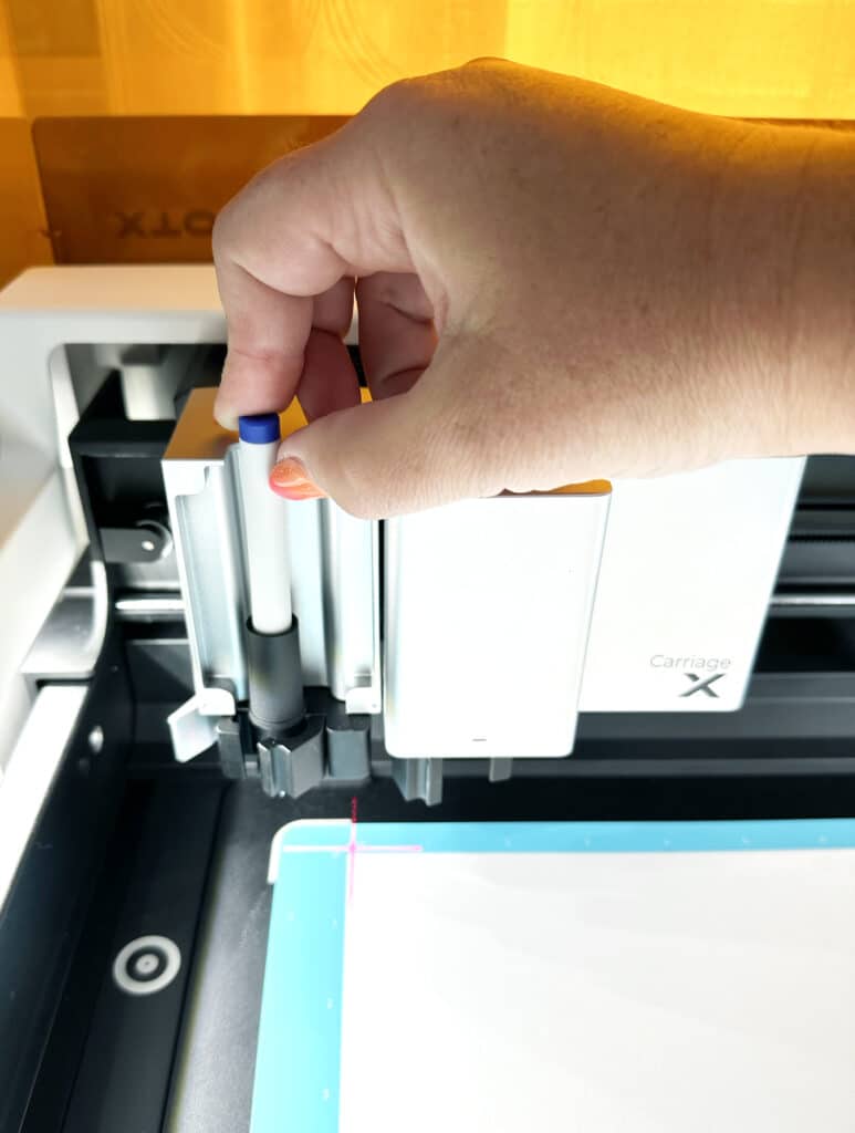 placing a pen in the xtool m1 ultra pen holder